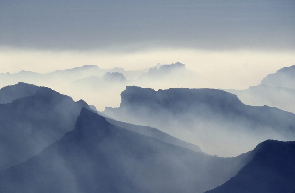 Misty mountain landscape with layered ridges