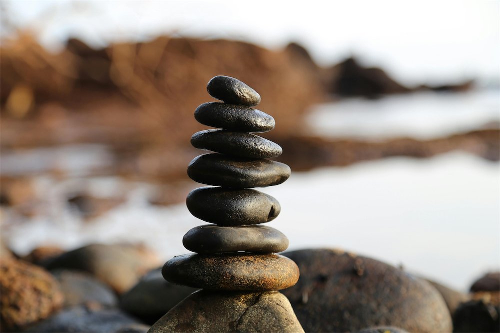 Stacked smooth stones by the water